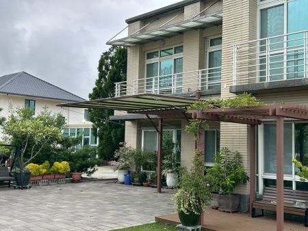 Steel Sail Shade Extending into Courtyard Greenery - Sail Shade in Courtyard Greenery